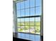 Bright window provides ample light and features a view of mature trees, greenery, and neighborhood homes at 195 14Th Ne St # 1507, Atlanta, GA 30309