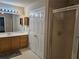 Bright bathroom with double sink vanity and shower with translucent door at 4620 Oak Grove Cir, Cumming, GA 30028
