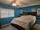 Bedroom with blue walls, a window with blinds, and a ceiling fan at 4620 Oak Grove Cir, Cumming, GA 30028