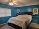 Bedroom with blue walls, a window with blinds, and a ceiling fan at 4620 Oak Grove Cir, Cumming, GA 30028