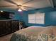 Bedroom featuring blue walls, a ceiling fan, and a window with blinds at 4620 Oak Grove Cir, Cumming, GA 30028