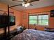 Bedroom featuring natural light, a four-poster bed, and view of the outdoors at 4620 Oak Grove Cir, Cumming, GA 30028