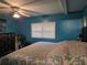 Bedroom with blue walls, a window with blinds, and a ceiling fan at 4620 Oak Grove Cir, Cumming, GA 30028