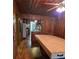 Dining room featuring wood paneled walls, view to kitchen and hardwood flooring at 4620 Oak Grove Cir, Cumming, GA 30028
