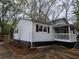 Well maintained home featuring a covered front porch, neat landscaping, and stylish exterior finishes at 4620 Oak Grove Cir, Cumming, GA 30028
