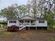 Charming single-story home with a welcoming front porch and meticulously kept landscaping at 4620 Oak Grove Cir, Cumming, GA 30028