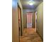 Hallway featuring hardwood floors with doorways leading to various rooms at 4620 Oak Grove Cir, Cumming, GA 30028