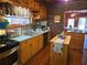 Country style kitchen featuring stainless steel appliances, wood floors and brick accents at 4620 Oak Grove Cir, Cumming, GA 30028