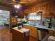Rustic kitchen features wood cabinets, stainless steel appliances, and a charming island at 4620 Oak Grove Cir, Cumming, GA 30028