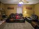 A cozy living room featuring leather seating, wooden wall decor, and warm lighting at 4620 Oak Grove Cir, Cumming, GA 30028