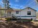 Exterior rear view of a house with a covered porch and wooden steps at 506 Carlton Dr, Palmetto, GA 30268