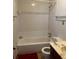 Bathroom with white tile shower over tub, white toilet, and painted vanity at 506 Carlton Dr, Palmetto, GA 30268