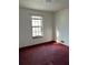 Vacant bedroom with neutral walls, red carpet, a window, and heating vent at 506 Carlton Dr, Palmetto, GA 30268