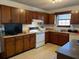 Traditional kitchen featuring wooden cabinets, appliances, and neutral countertops at 506 Carlton Dr, Palmetto, GA 30268
