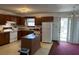 Kitchen featuring ample counter space, an island, and an adjacent dining area with natural light at 506 Carlton Dr, Palmetto, GA 30268