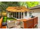 Relaxing outdoor deck featuring a grill and stylish seating with an umbrella for shade at 648 Channing Nw Dr, Atlanta, GA 30318