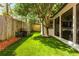 This backyard has a well-maintained lawn and landscaping, as well as an outdoor patio at 648 Channing Nw Dr, Atlanta, GA 30318