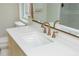 Bathroom vanity area with a spacious countertop, bronze faucet, and contemporary mirror at 648 Channing Nw Dr, Atlanta, GA 30318