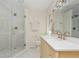 Modern bathroom with a glass-enclosed shower, double vanity, and elegant fixtures at 648 Channing Nw Dr, Atlanta, GA 30318