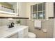 Cozy bathroom featuring tiled walls, a vanity with a sleek countertop, and a well-lit mirror at 648 Channing Nw Dr, Atlanta, GA 30318