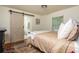 Bright bedroom with a sliding barn door, plush bedding, and a colorful rug on hardwood floors at 648 Channing Nw Dr, Atlanta, GA 30318