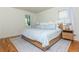 This bedroom has a wooden bed frame, hardwood floors, and bright natural lighting at 648 Channing Nw Dr, Atlanta, GA 30318