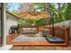 Outdoor deck with a barbecue grill and stylish seating area under a large umbrella at 648 Channing Nw Dr, Atlanta, GA 30318