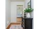 Hallway with hardwood floors, a dresser with decorations, and a view into a bedroom at 648 Channing Nw Dr, Atlanta, GA 30318