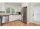 Bright kitchen featuring white cabinets, stainless steel appliances, and granite countertops at 648 Channing Nw Dr, Atlanta, GA 30318