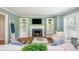 Stylish living room with fireplace, white bookshelves, plush sofas, hardwood floors and modern decor at 648 Channing Nw Dr, Atlanta, GA 30318