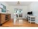 Bright home office with hardwood floors, French doors to the patio, and a modern desk setup at 648 Channing Nw Dr, Atlanta, GA 30318