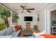 This is a sunroom featuring a ceiling fan, plants, and comfortable seating at 648 Channing Nw Dr, Atlanta, GA 30318
