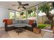 Relaxing outdoor patio with wicker furniture, a ceiling fan, and views of the lush backyard at 648 Channing Nw Dr, Atlanta, GA 30318