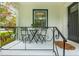 Charming porch with black iron furniture, a welcome mat, and view of the landscaped front yard at 648 Channing Nw Dr, Atlanta, GA 30318