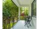 Cozy front porch with metal furniture offering a relaxing outdoor space with a view of the lush greenery at 648 Channing Nw Dr, Atlanta, GA 30318