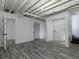Finished basement area with light gray floors, white walls and ceiling, and doorways to other rooms at 7965 Tower Dr, Douglasville, GA 30134