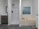 Bathroom featuring a tub, vanity, shower, and frosted window at 7965 Tower Dr, Douglasville, GA 30134