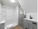 Bathroom with white shower, gray vanity, gray flooring, and modern fixtures at 7965 Tower Dr, Douglasville, GA 30134