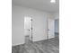 Bedroom with gray flooring and view of the bathroom and another bedroom through open doorways at 7965 Tower Dr, Douglasville, GA 30134