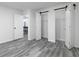 Bright bedroom features closet with sliding doors, gray flooring, and neutral decor at 7965 Tower Dr, Douglasville, GA 30134