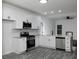 Bright kitchen featuring white cabinets, stainless appliances, gray flooring, and granite countertops at 7965 Tower Dr, Douglasville, GA 30134