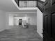 Open-concept layout with views into a modern kitchen featuring white cabinets, stainless appliances and gray flooring at 7965 Tower Dr, Douglasville, GA 30134