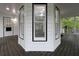 Enclosed porch featuring multiple windows offering green views, with a door on the left at 7965 Tower Dr, Douglasville, GA 30134