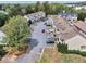 Aerial view of townhomes featuring ample parking, trees, and well-maintained exteriors at 1797 Brookside Lay Cir, Norcross, GA 30093