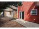 Backyard of red townhome with concrete patio and a wooden fence at 1797 Brookside Lay Cir, Norcross, GA 30093
