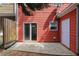 Red townhouse with a sliding glass door to a patio with a wooden fence at 1797 Brookside Lay Cir, Norcross, GA 30093