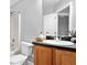 Bathroom featuring a tub and shower combo, white toilet and wood vanity at 1797 Brookside Lay Cir, Norcross, GA 30093