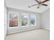 Bright bedroom with three windows offering natural light, complemented by a ceiling fan at 1797 Brookside Lay Cir, Norcross, GA 30093