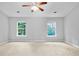 Spacious bedroom with neutral carpet and natural light from two windows at 1797 Brookside Lay Cir, Norcross, GA 30093