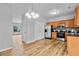 Bright kitchen with stainless steel appliances, wood cabinets, and wood-look floors at 1797 Brookside Lay Cir, Norcross, GA 30093